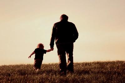 A daddy walking with his daughter
